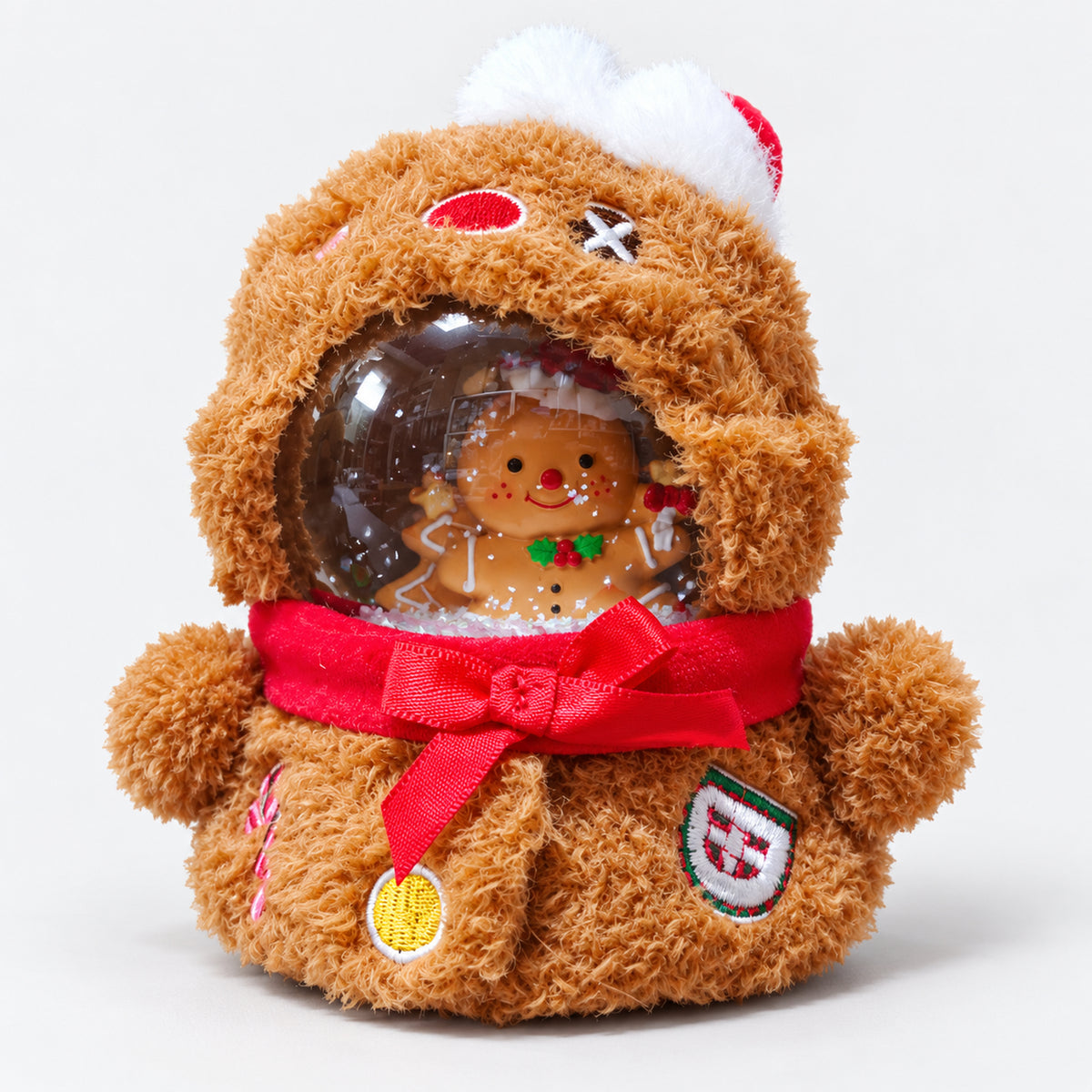 Gingerbread plush snow globe with a red scarf and a gingerbread man inside the dome