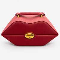 Burgundy lips-shaped jewelry case with a gold-tone lock and top handle
