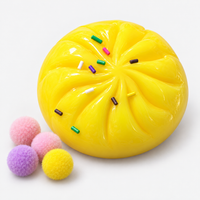 Dumpling squishy in yellow with sprinkles and fuzzy pompoms
