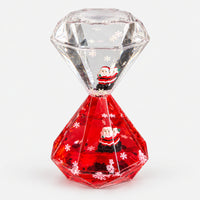 Christmas diamond hourglass with red liquid, snowflakes and Santa figures
