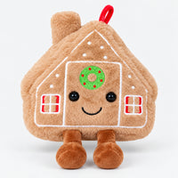 Soft gingerbread house plushie with a smiling face, wreath and little feet