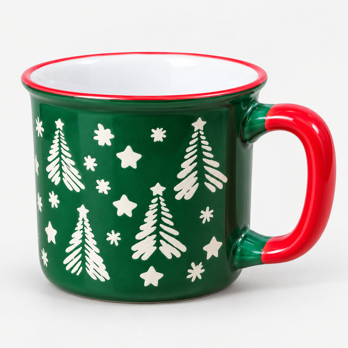 Green Christmas camp mug with white trees, stars and a red handle