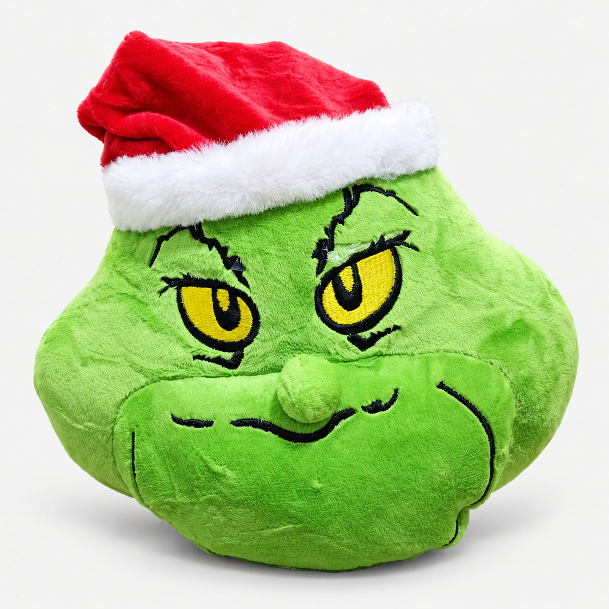 Green Christmas character plushie with yellow eyes and a Santa hat