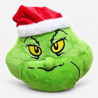 Green Christmas character plushie with yellow eyes and a Santa hat