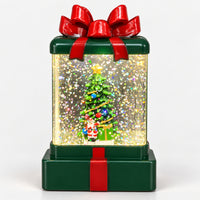 Christmas gift box lantern lit up with sparkling glitter