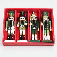 4 green nutcracker figures in a red gift box with a clear lid