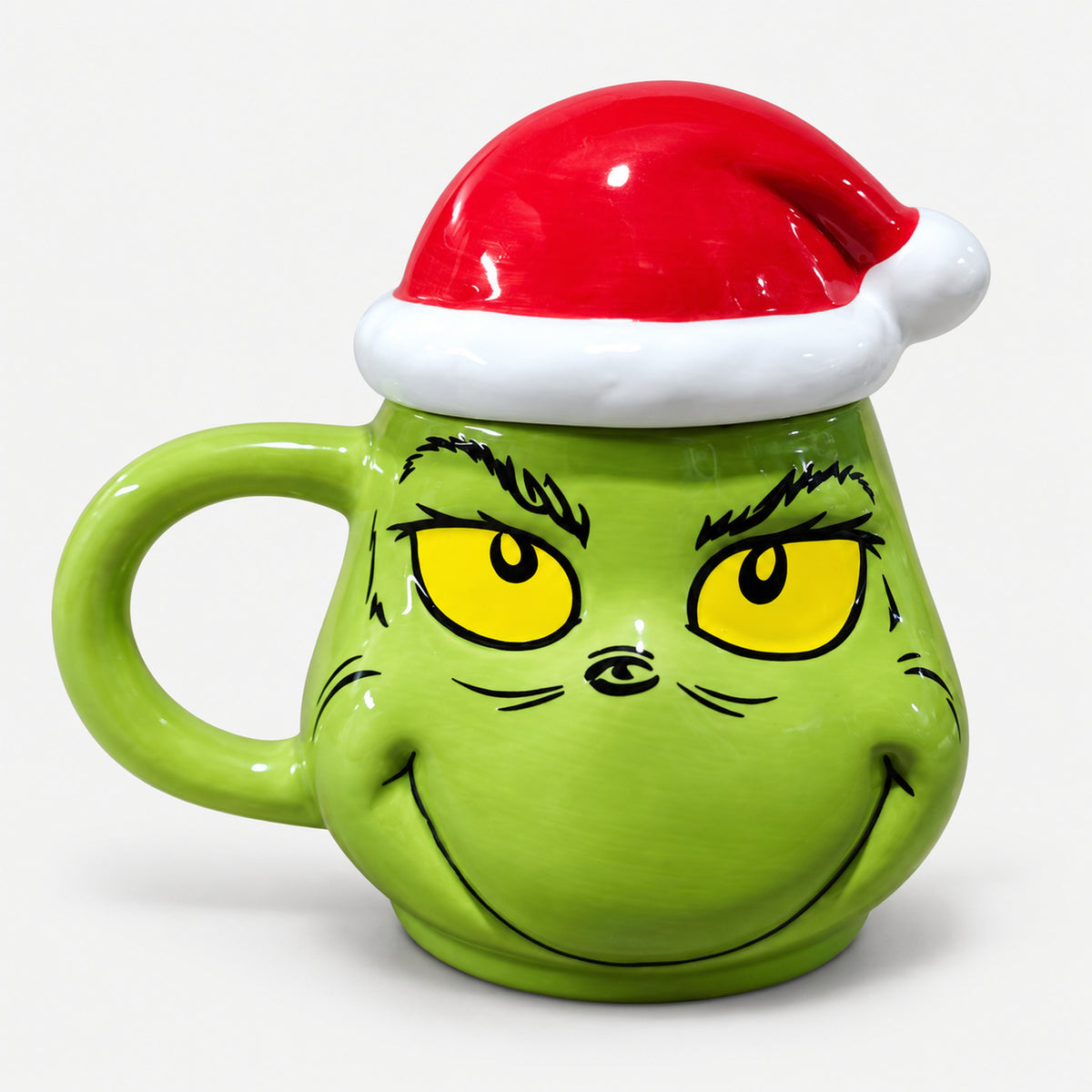 Green character Christmas mug with a red Santa hat lid