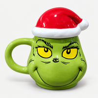 Green character Christmas mug with a red Santa hat lid