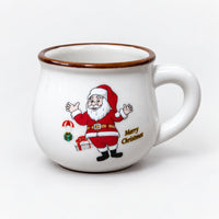 White rounded Christmas mug with a Santa arms up print and gold Merry Christmas