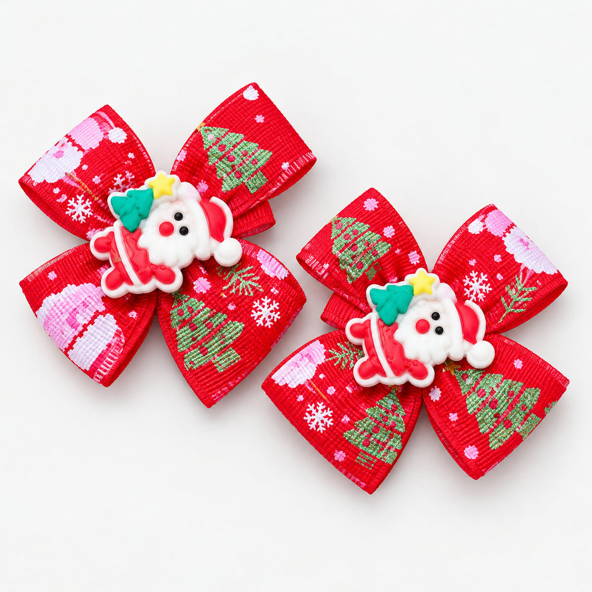 Pair of red Christmas bow hair clips with a Santa charm