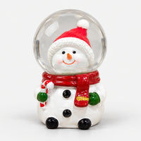 Snowman Christmas snow globe with a Santa hat, red scarf and candy cane