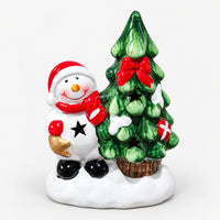 Snowman in a red hat next to a Christmas tree with a red bow, LED decoration unlit