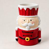Tall nutcracker Christmas cup with a red hat, white mustache and red jacket