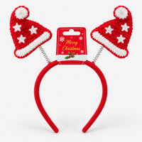 Red Christmas headband with two bouncy Santa hats on its Merry Christmas card