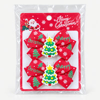 Christmas tree bow hair clips on a Merry Christmas card