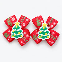Pair of red Christmas bow hair clips with a Christmas tree charm