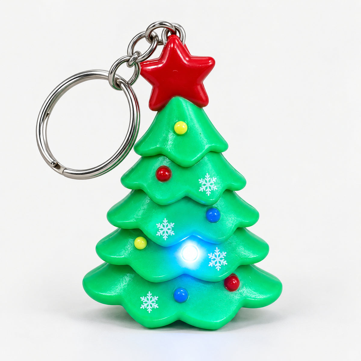 Christmas tree keychain with its LED light on