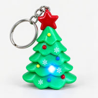 Christmas tree keychain with its LED light on