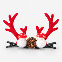 Pair of red antler Christmas hair clips with red and white mushrooms