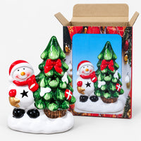 Snowman and tree LED decoration next to its printed gift box
