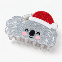 Silver glitter koala claw hair clip wearing a red Santa hat