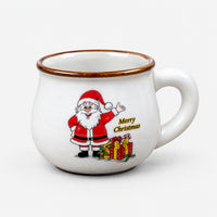 White large rounded Christmas mug with Santa waving next to a pile of gifts