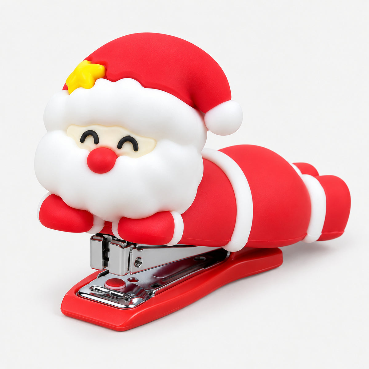 Red mini stapler with a smiling Santa lying on top