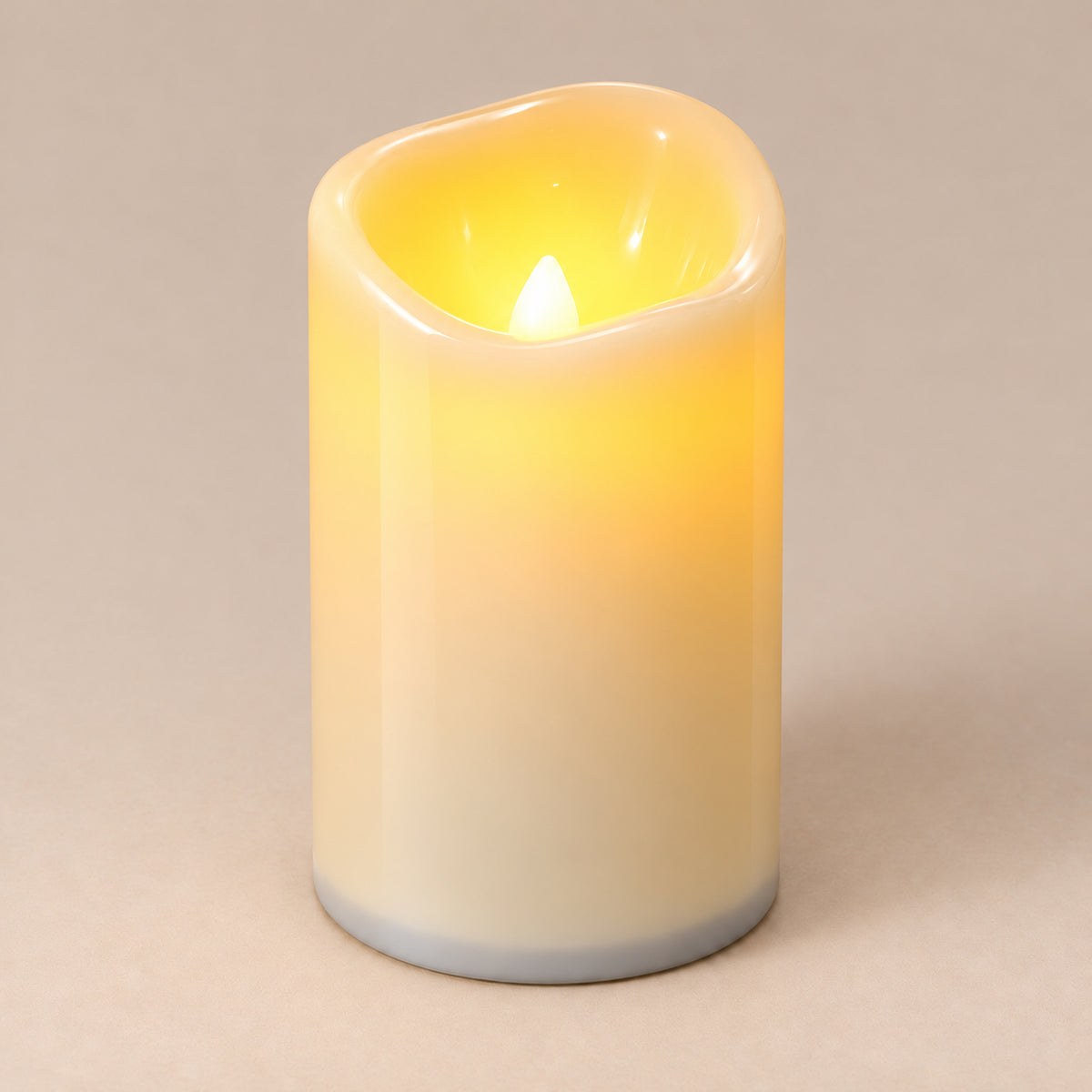 Ivory LED pillar candle, 12 cm, switched on with a warm flickering flame