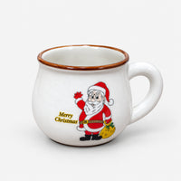 White large rounded Christmas mug with Santa waving and a yellow sack