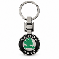 Metal car logo keychain with a round black and green logo