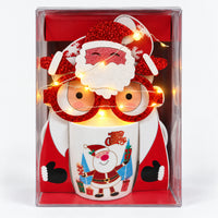 Christmas mug gift box with white Santa and blue trees design and light-up glasses switched on