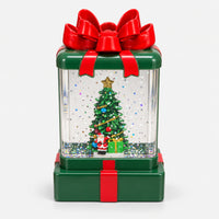 Green Christmas gift box lantern with a red bow, Christmas tree and Santa inside