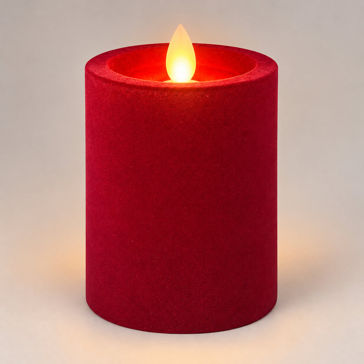 Burgundy 10 cm LED pillar candle glowing with a dancing flame