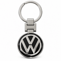Metal car logo keychain with a round black and silver logo