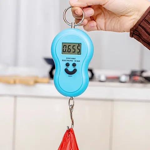 Hand holding a portable hanging digital scale with a bag on the hook