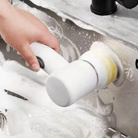 Electric cleaning brush with yellow sponge head scrubbing a sink