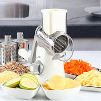 Rotary vegetables grater and slicer with grated cheese, carrots and sliced zucchini