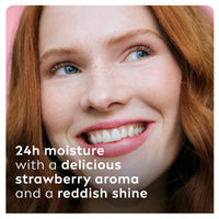 Woman wearing strawberry shine lip balm with a sheer reddish shine