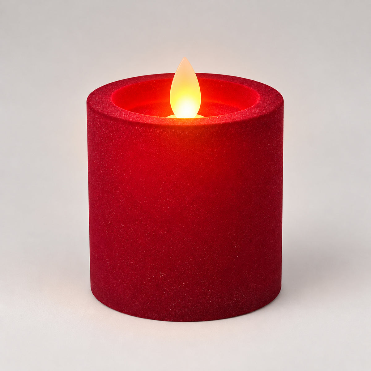 Burgundy 7.5 cm LED pillar candle glowing with a dancing flame
