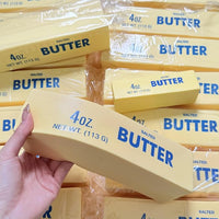 Hand squeezing a butter stick squishy