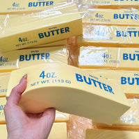 Hand holding a butter stick squishy