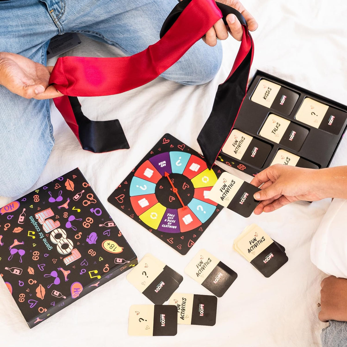 LOOPY spinner board, cards and satin blindfold laid out