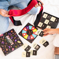 LOOPY spinner board, cards and satin blindfold laid out