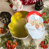 Santa face Christmas tin box open, showing the gold inside
