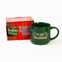 Green Christmas quote mug "Merry Christmas" in gold next to its striped gift box