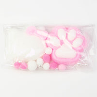 Pink and white kitty paw squishy in a pouch with pompoms and pearls