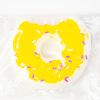 Donut bite squishy with yellow icing and rainbow sprinkles