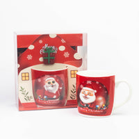Red Santa Christmas mug next to its house-shaped gift box
