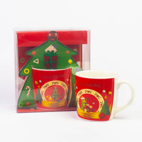 Red Christmas mug next to its Christmas tree gift box