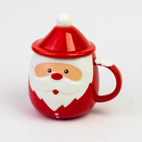 Ceramic Santa mug with a red Santa hat lid and pom-pom spoon